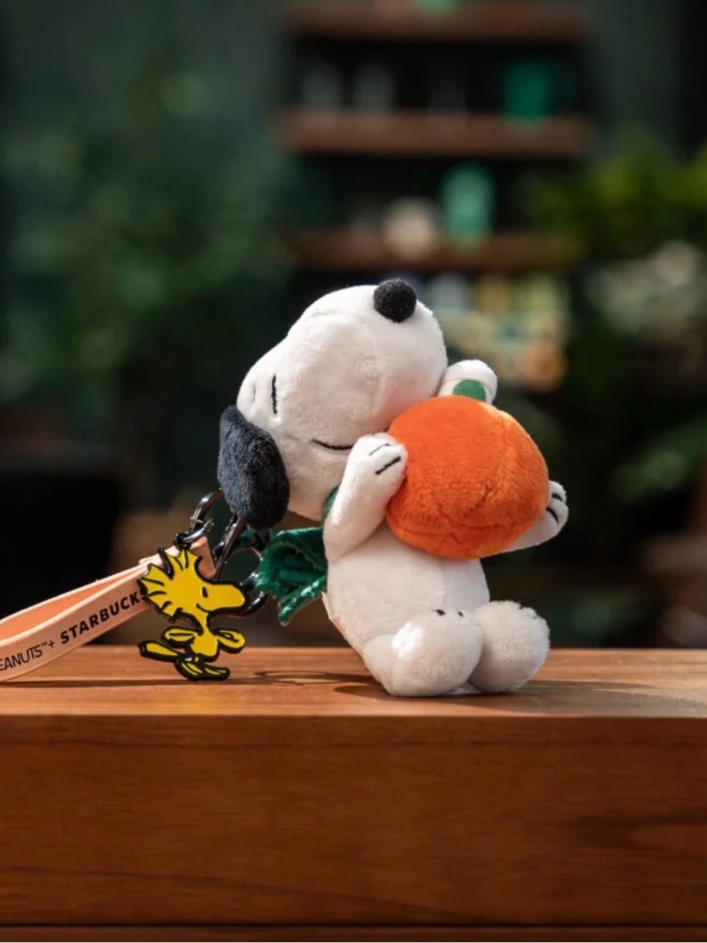 Starbucks White Snoopy Plush Keychain Holding Orange